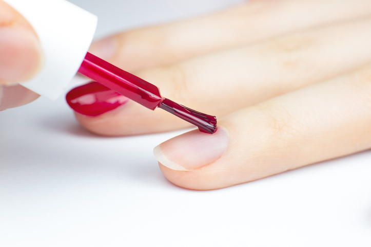 Girl making a manicure. Salon procedures at home. Beautiful hands and nails. Close up, macro photo.